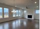 Bright living room features hardwood floors, large windows, and a fireplace at 5043 Baywood Ln, Woodstock, GA 30188