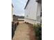 A side yard next to a modern home is staged with pine straw at 5043 Baywood Ln, Woodstock, GA 30188
