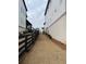 A view of the side yard between houses with a fence and newly planted greenery at 5043 Baywood Ln, Woodstock, GA 30188