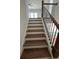 Staircase with wood treads, white risers, and black iron railing at 5043 Baywood Ln, Woodstock, GA 30188