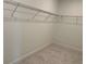 Walk-in closet boasts ample storage space with wire shelving and neutral carpeting at 5043 Baywood Ln, Woodstock, GA 30188