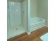Bathroom with tub, shower, and wood flooring at 6636 Saint Jude Dr, Fairburn, GA 30213