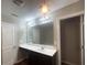 Bathroom with vanity, mirror, and chandelier at 6636 Saint Jude Dr, Fairburn, GA 30213