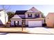 Two-story house with gray siding, white trim, and a two-car garage at 6636 Saint Jude Dr, Fairburn, GA 30213
