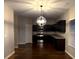 Modern kitchen with dark cabinets, granite countertops, and stainless steel appliances at 6636 Saint Jude Dr, Fairburn, GA 30213