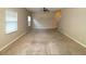 Large living area with neutral walls and carpeted floors at 6636 Saint Jude Dr, Fairburn, GA 30213