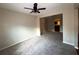 Spacious living room with neutral carpeting and a ceiling fan at 6636 Saint Jude Dr, Fairburn, GA 30213