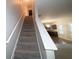 Carpeted staircase leading to the second floor of the home at 6636 Saint Jude Dr, Fairburn, GA 30213