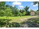 Large backyard with grassy area and storage building at 1215 Brook Meadow Ct, Lawrenceville, GA 30045