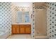 Bathroom with wood vanity, shower, and floral wallpaper at 1215 Brook Meadow Ct, Lawrenceville, GA 30045