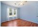 Light blue bedroom with wood floors and large windows at 1215 Brook Meadow Ct, Lawrenceville, GA 30045