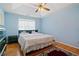 Main bedroom features a king-size bed and ceiling fan at 1215 Brook Meadow Ct, Lawrenceville, GA 30045