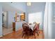 Bright dining room features wood floors and a charming table with chairs at 1215 Brook Meadow Ct, Lawrenceville, GA 30045