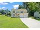 Two-story house with a two-car garage and landscaped lawn at 1215 Brook Meadow Ct, Lawrenceville, GA 30045
