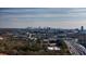 Scenic aerial view of the Atlanta skyline surrounded by lush trees with highways and buildings nearby at 2732 Suwanee Se Way, Marietta, GA 30067
