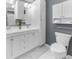 Well-lit bathroom featuring a double vanity, a toilet, and modern white cabinetry at 2732 Suwanee Se Way, Marietta, GA 30067