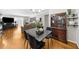 Open concept dining area with hardwood floors, stylish dining table, and adjacent living space at 2732 Suwanee Se Way, Marietta, GA 30067