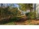 Pathway through a natural area, showcasing lush greenery and surrounding community buildings at 2732 Suwanee Se Way, Marietta, GA 30067