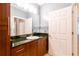 Bathroom with wood cabinets, granite countertop, and a sink at 400 17Th Nw St # 2118, Atlanta, GA 30363