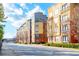 Modern apartment building with tree-lined street and city views in the background at 400 17Th Nw St # 2118, Atlanta, GA 30363