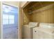 Convenient laundry closet with washer, dryer, and shelving at 400 17Th Nw St # 2118, Atlanta, GA 30363