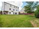 Large backyard with green grass, a wooden fence, and a patio at 5060 Lloyd Ln, Cumming, GA 30040