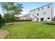 Spacious backyard with grassy lawn, wooden fence, and patio at 5060 Lloyd Ln, Cumming, GA 30040