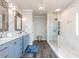 Elegant bathroom with dual vanities, a large shower, and marble flooring at 5060 Lloyd Ln, Cumming, GA 30040