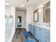Bathroom boasts dual vanities, a large shower, and marble flooring at 5060 Lloyd Ln, Cumming, GA 30040