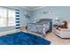 Charming bedroom with a nautical theme and a comfy sitting area at 5060 Lloyd Ln, Cumming, GA 30040