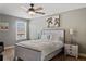 Spacious bedroom with light wood platform bed and ceiling fan at 5060 Lloyd Ln, Cumming, GA 30040
