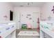 Charming bedroom with twin beds, playful rug, and ample storage at 5060 Lloyd Ln, Cumming, GA 30040