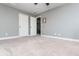 Large bonus room with new carpet and two doorways leading to other rooms at 5060 Lloyd Ln, Cumming, GA 30040