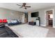 Bonus room with sectional sofa, large TV, and adjacent bathroom at 5060 Lloyd Ln, Cumming, GA 30040