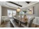 Farmhouse style dining room with a large wooden table and chandelier at 5060 Lloyd Ln, Cumming, GA 30040