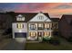 Two-story home with white brick, brown accents, and a welcoming front porch at 5060 Lloyd Ln, Cumming, GA 30040