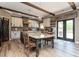 Open kitchen with breakfast bar, island, and exposed beams at 5060 Lloyd Ln, Cumming, GA 30040