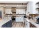 Spacious kitchen with white cabinets, granite countertops and a rustic range hood at 5060 Lloyd Ln, Cumming, GA 30040