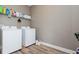 Laundry room with washer, dryer, and overhead storage at 5060 Lloyd Ln, Cumming, GA 30040