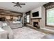 Living room with fireplace, hardwood floors and open concept to kitchen at 5060 Lloyd Ln, Cumming, GA 30040