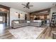 Open concept living room with hardwood floors and access to kitchen at 5060 Lloyd Ln, Cumming, GA 30040