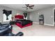 Main bedroom with a red upholstered bed, leather recliner, and mini-fridge at 5060 Lloyd Ln, Cumming, GA 30040