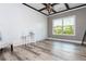 Spacious office with wood-look floors, shiplap accent wall and large window at 5060 Lloyd Ln, Cumming, GA 30040