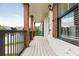 Covered porch with wood columns and white brick exterior at 5060 Lloyd Ln, Cumming, GA 30040