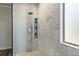 Spa-like shower with patterned tile and built-in shelving at 5060 Lloyd Ln, Cumming, GA 30040