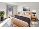 Main bedroom with a large window and modern light wood furniture at 7239 Wiley Ct, Riverdale, GA 30274