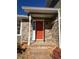 Brick house with an orange front door and a brick walkway at 3164 Windfield Cir, Tucker, GA 30084