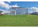 Large backyard with grassy lawn and covered patio at 328 Meuse Ln, Locust Grove, GA 30248