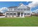 Two story house with gray siding, white trim, and a grassy lawn at 328 Meuse Ln, Locust Grove, GA 30248
