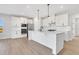 Modern kitchen with white cabinets, island, and stainless steel appliances at 328 Meuse Ln, Locust Grove, GA 30248